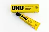 Lefkada, Greece- 10.03.2024. The package and a tube of glue of the German manufacturer of adhesive products UHU, showing the brand and company name, isolated in white.