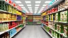 Supermarket interior with shelves full of various products.